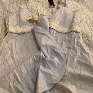 Baby blue sleeveless blouse with ruffles